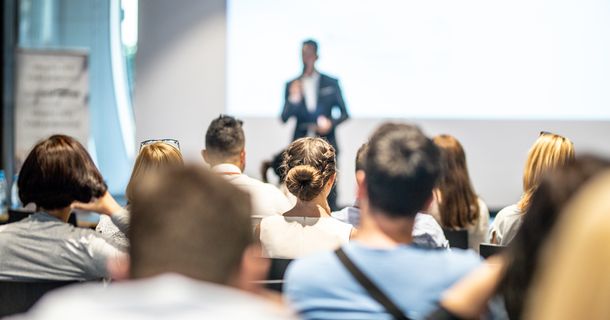 Speaker hält Vortrag vor Menschenmenge