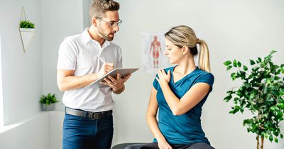 Physiotherapeut befundet eine Patientin