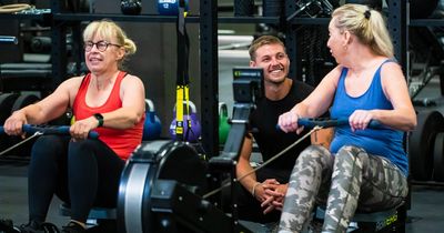Zwei ältere Damen trainieren unter Aufsicht von Trainer