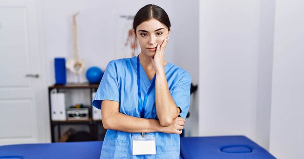 Unzufriedener Physiotherapeut vor einer Behandlungsliege