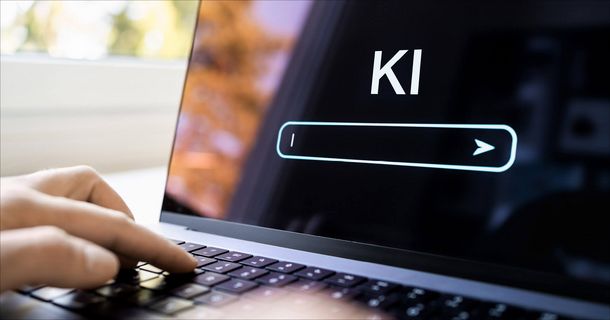 Hand vor Laptop mit KI Screen