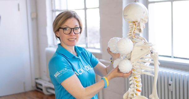 Dr. Tanja Kühne mit ihren Ballance Balls vor einem Skelett